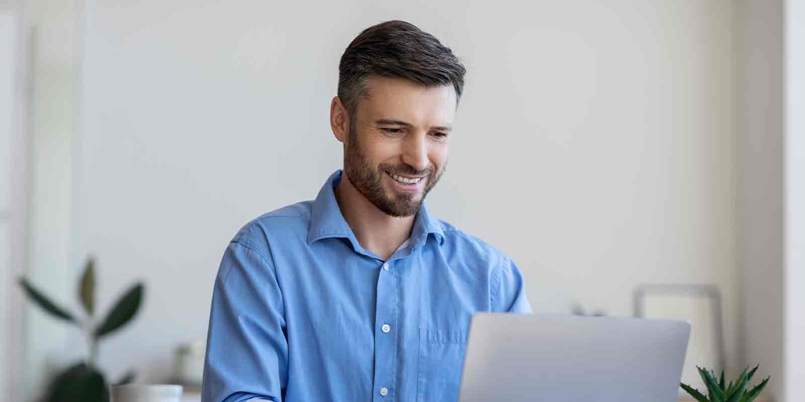 man on computer at home doing investment planning