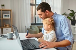 man at home with kid doing his Investment Planning