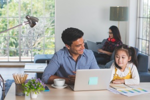 man doing Portfolio Management at home with kids