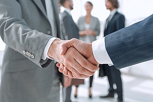 a financial advisor shaking hands with a client