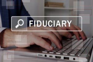 FIDUCIARY phrase on the screen and a man is using his laptop in the backgrounf