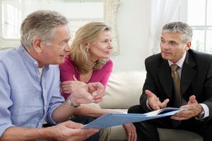 An old age couple consulting a financial advisor for retirement planning